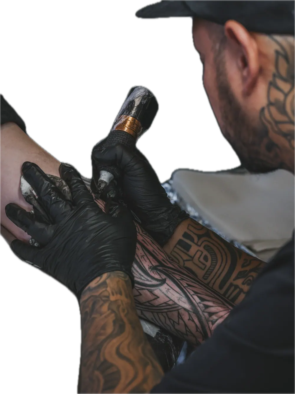 Tattoo artist applying ink to a client's arm