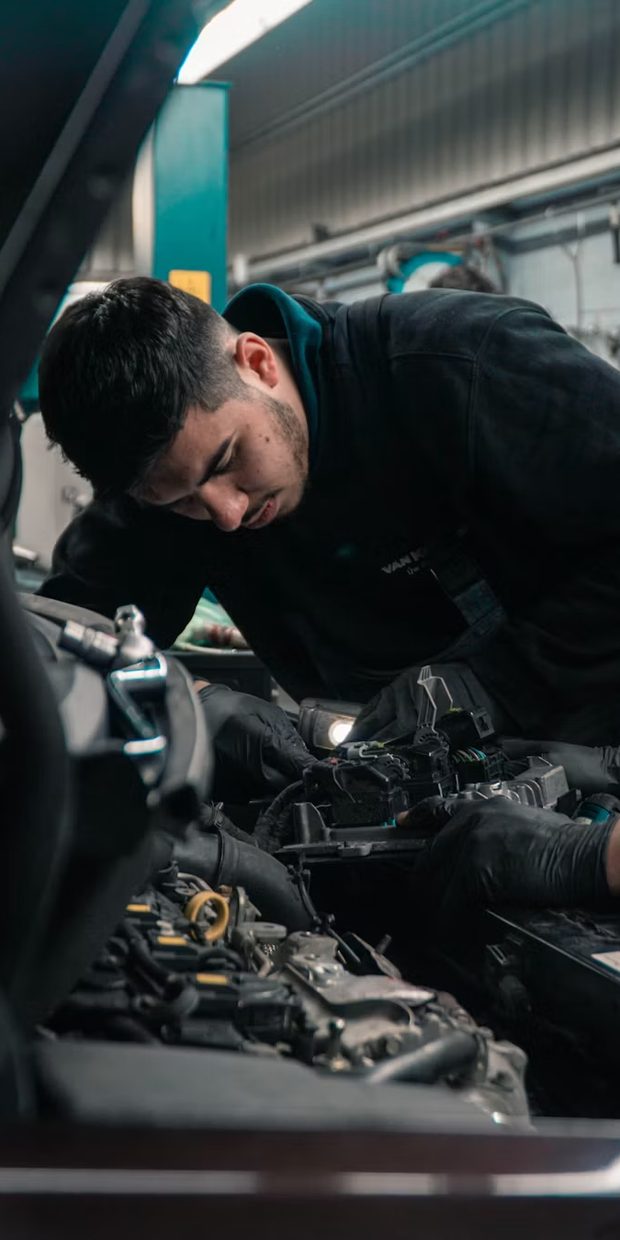 Mechanic working under a car bonnet