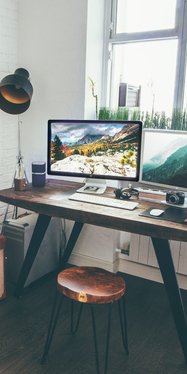 A home desk with a computer by a window